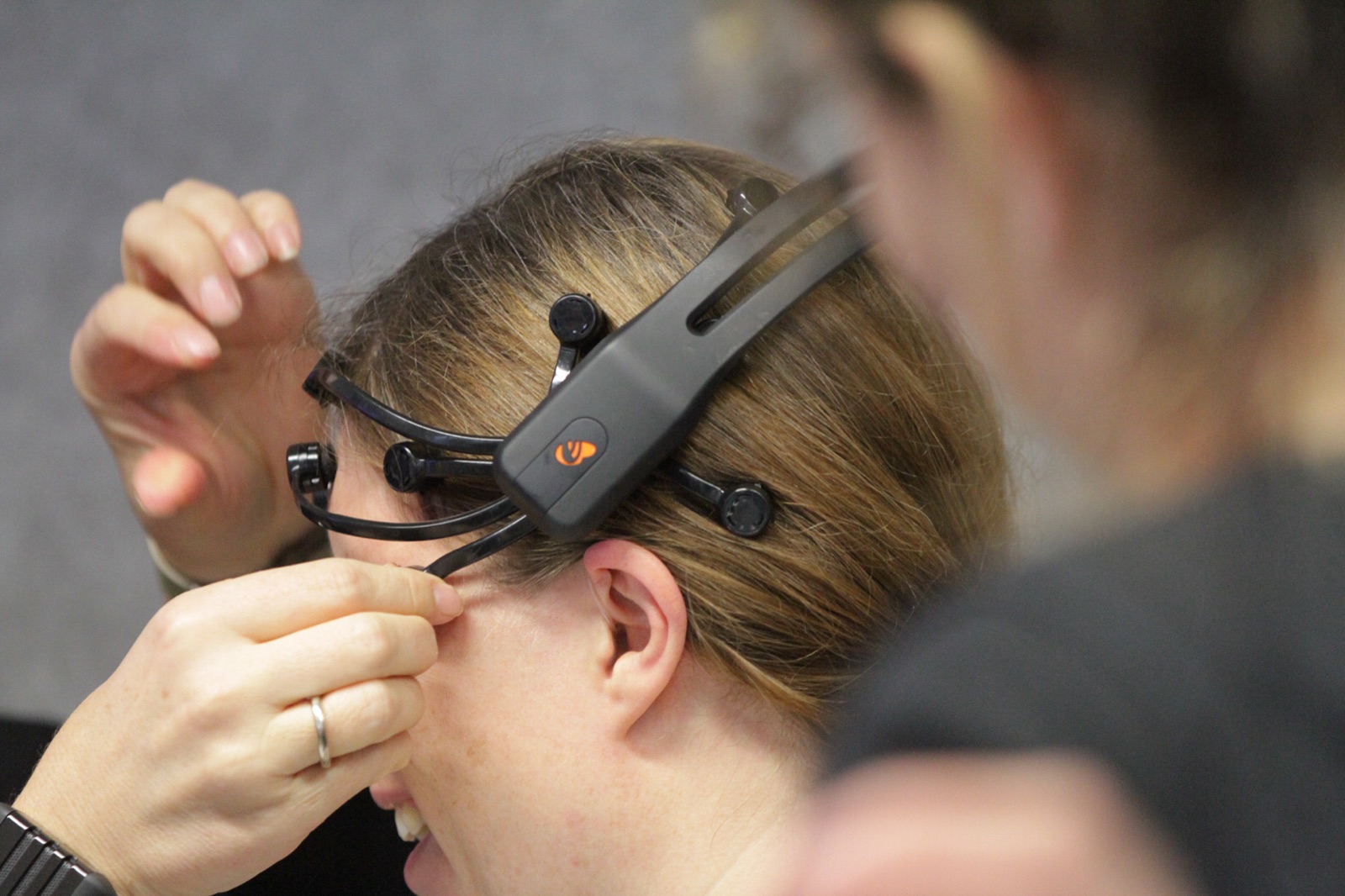 A workshop participant putting on a mobile EEG headset